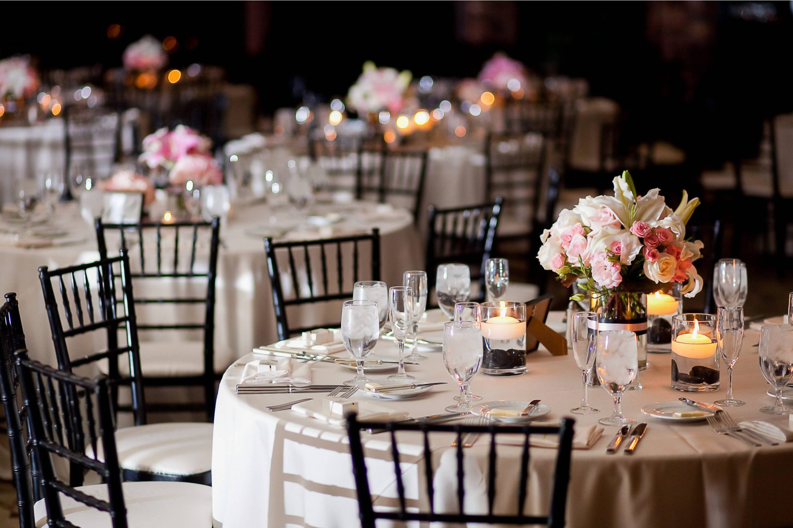 A table set up with many tables and chairs