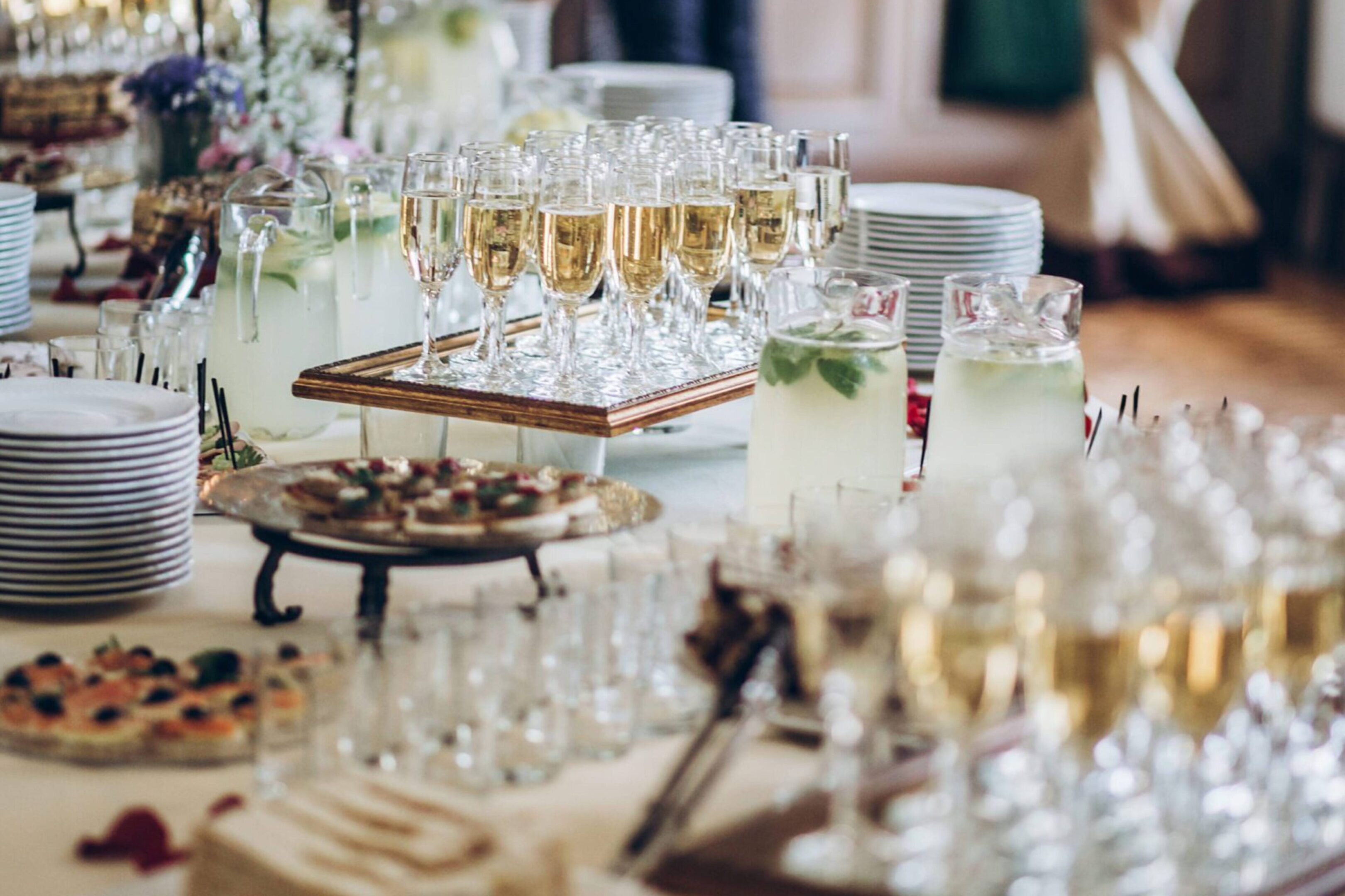 A table with many glasses of champagne and other drinks.