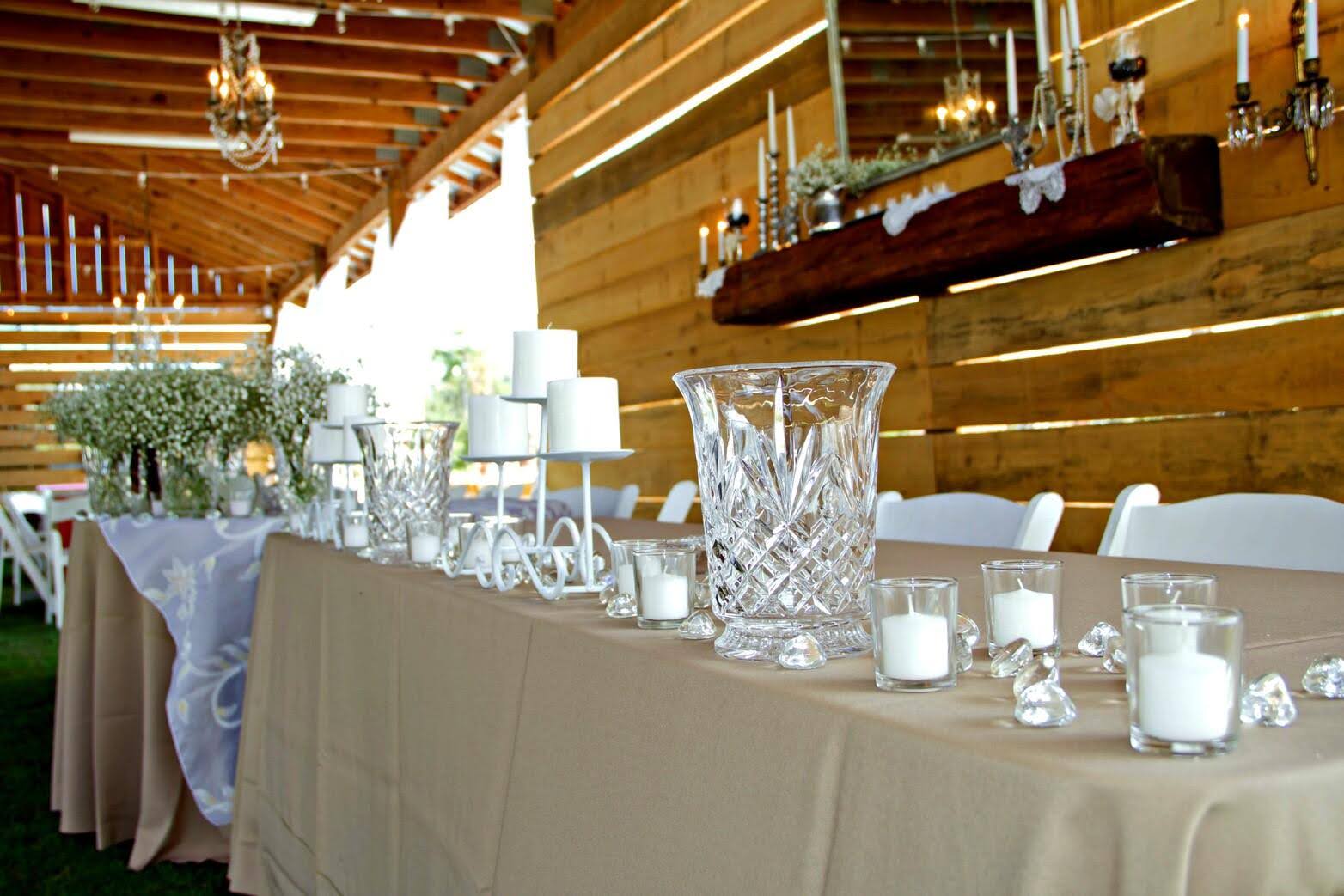 A table with candles and vases on it